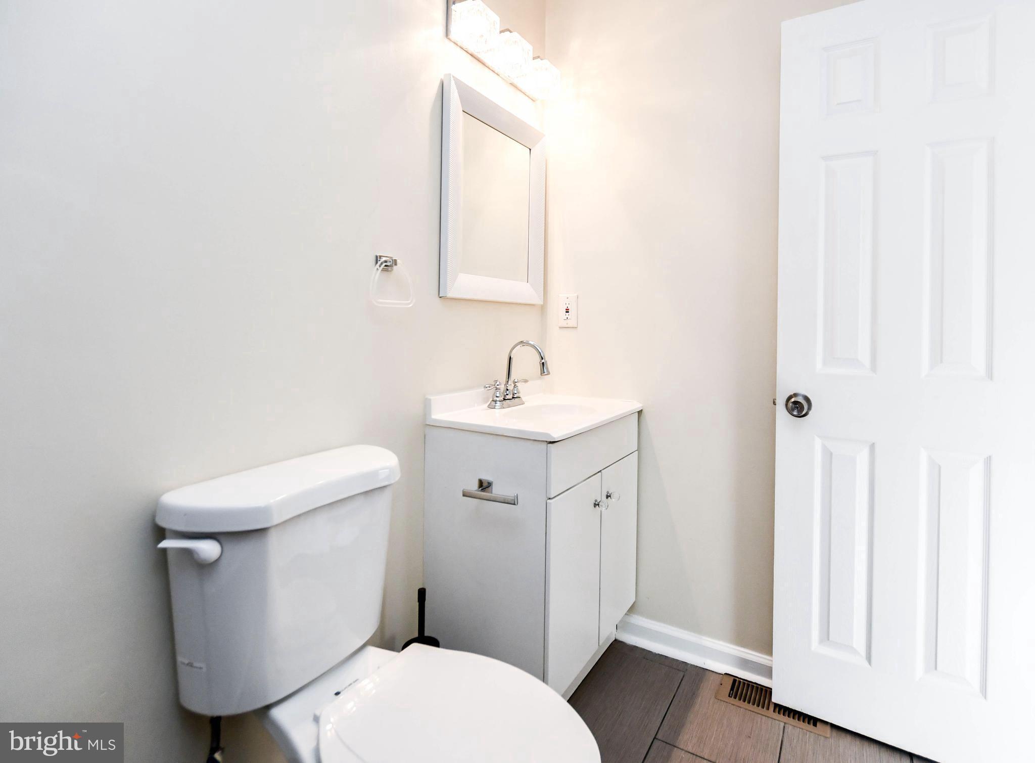 2115 North Anvil Lane Temple Hills, MD 20748 - Photo 26 of 37 a white toilet sitting next to a bathroom sink