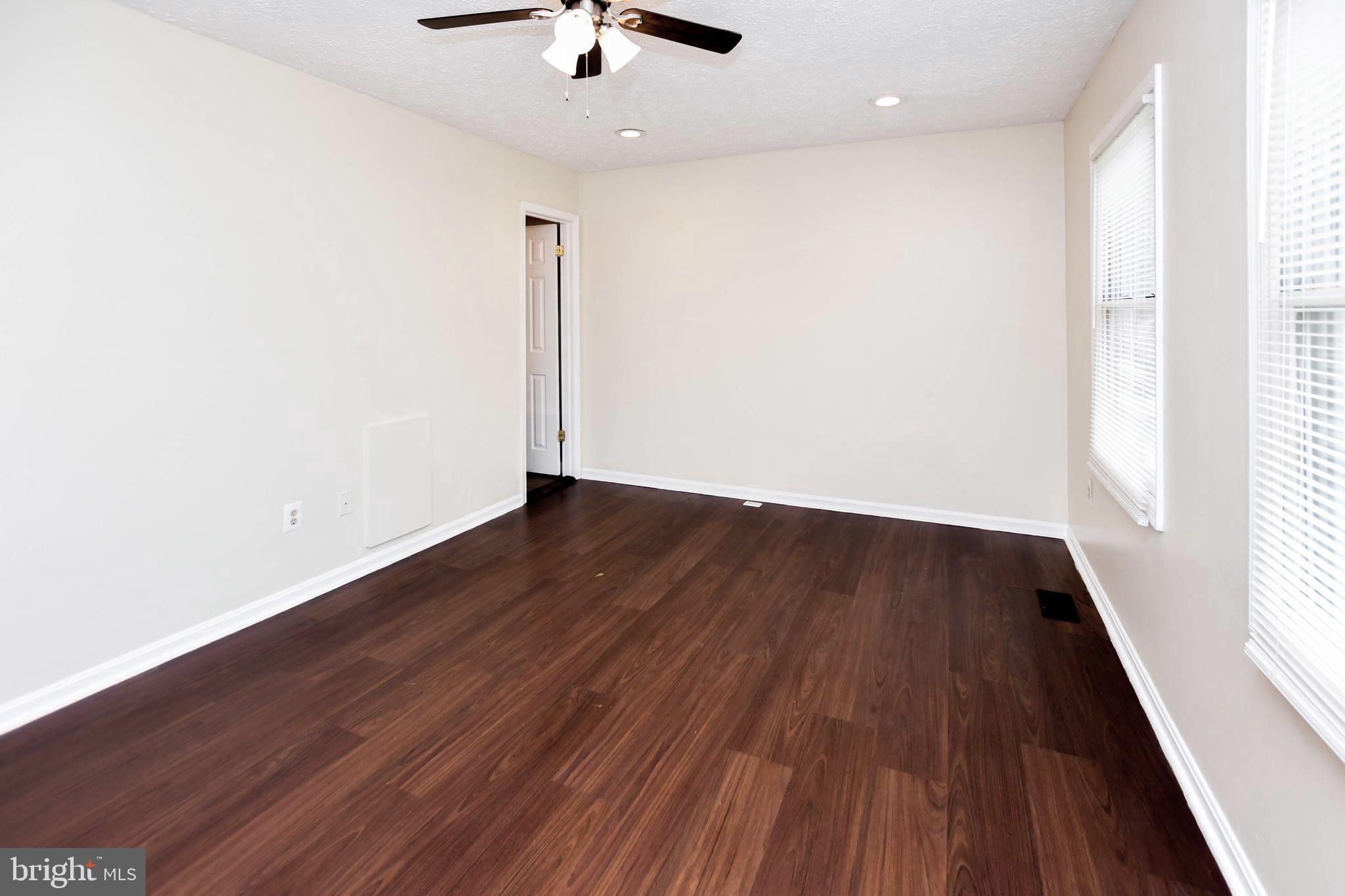 2115 North Anvil Lane Temple Hills, MD 20748 - Photo 29 of 37 wooden floor in an empty room with a window