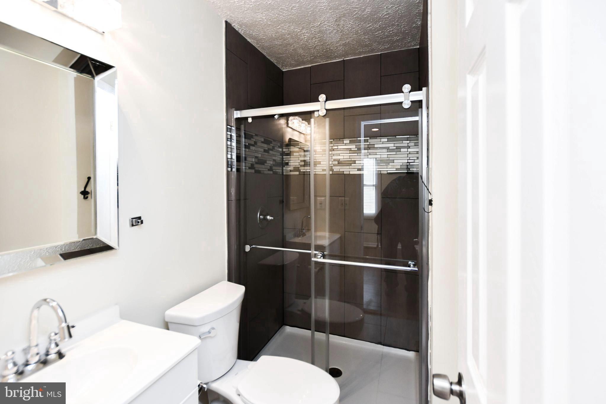 2115 North Anvil Lane Temple Hills, MD 20748 - Photo 30 of 37 a bathroom with a shower toilet and sink