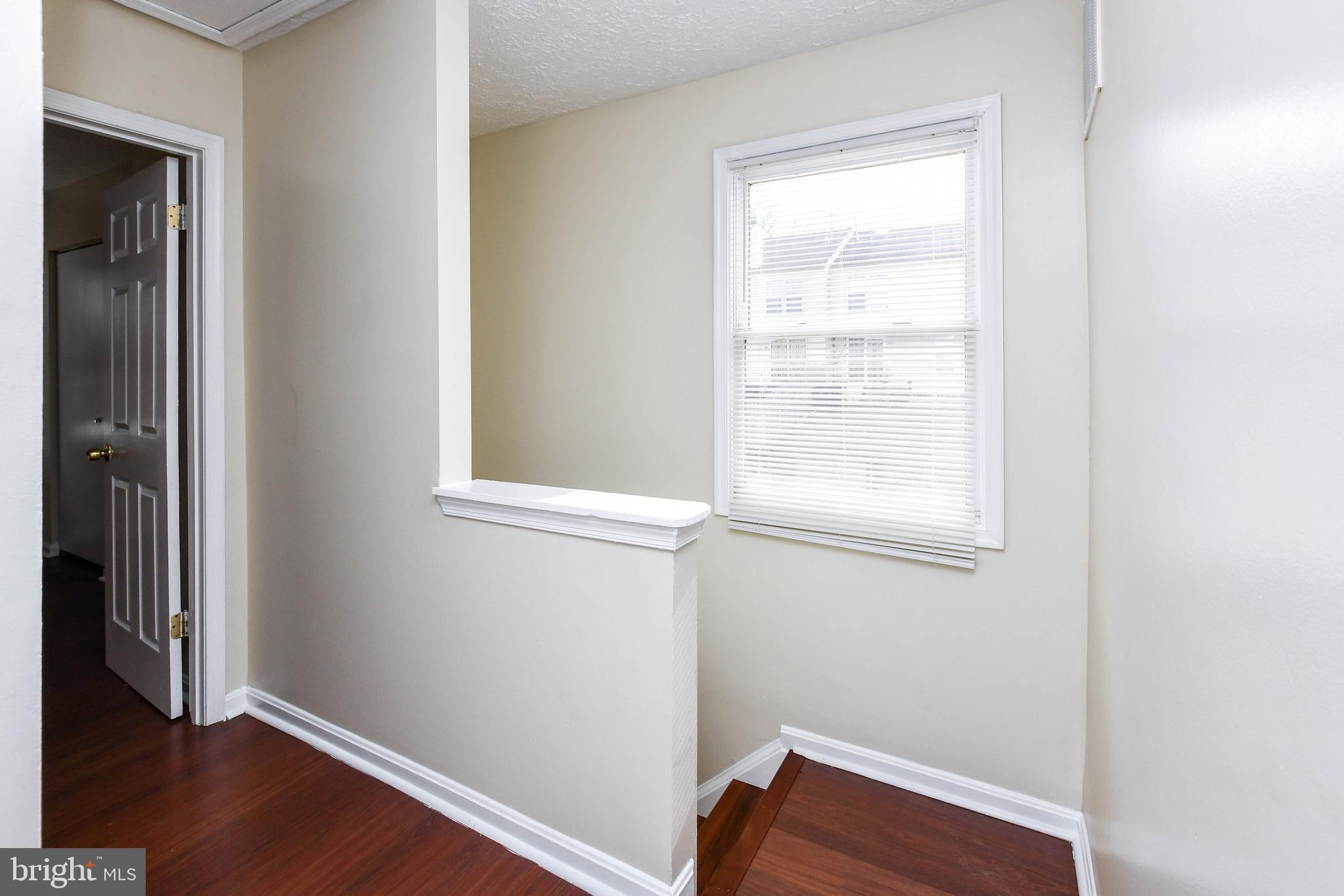 2115 North Anvil Lane Temple Hills, MD 20748 - Photo 34 of 37 a room with a window and wooden floor