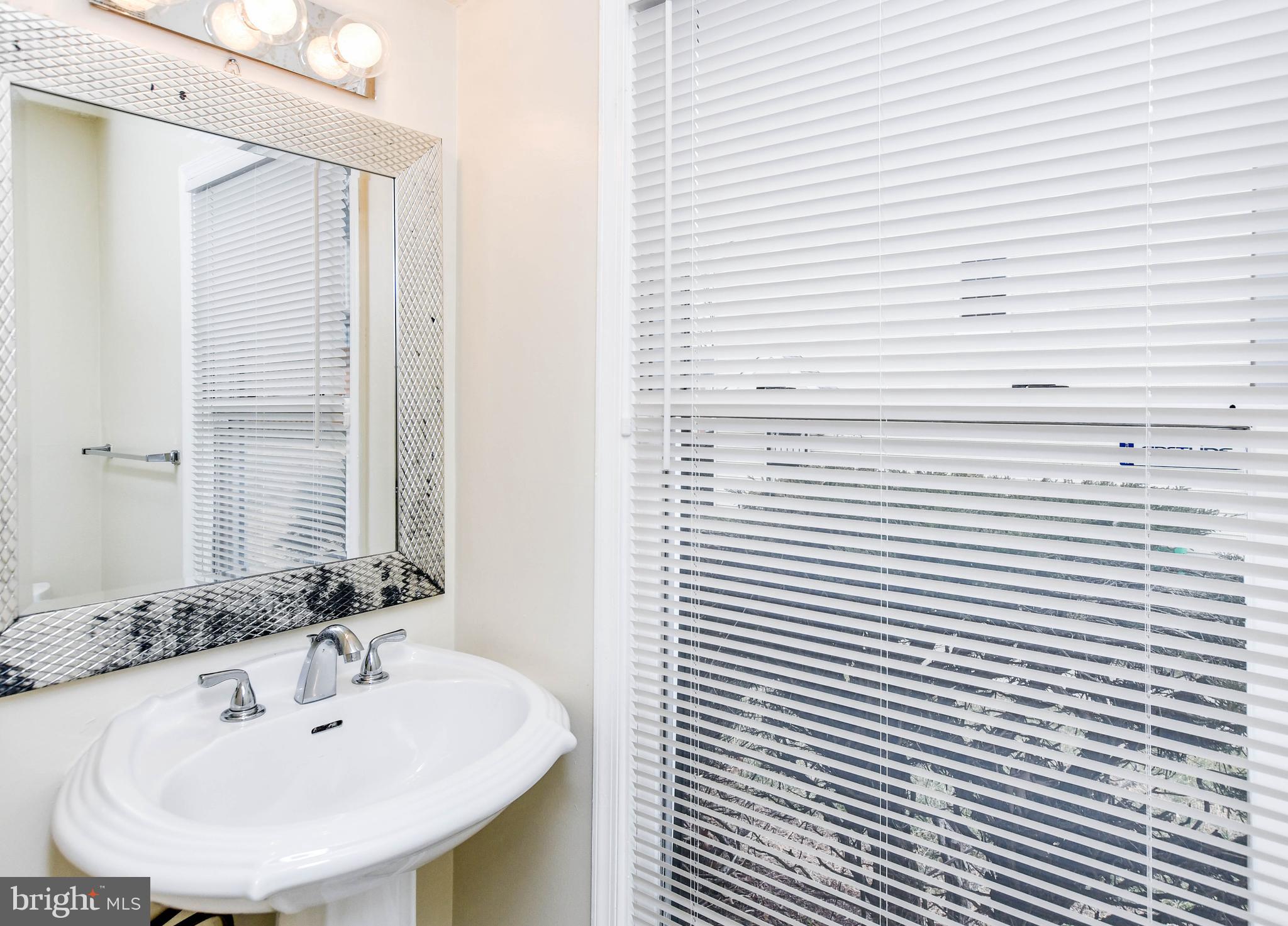 2115 North Anvil Lane Temple Hills, MD 20748 - Photo 4 of 37 a bathroom with a sink and a mirror