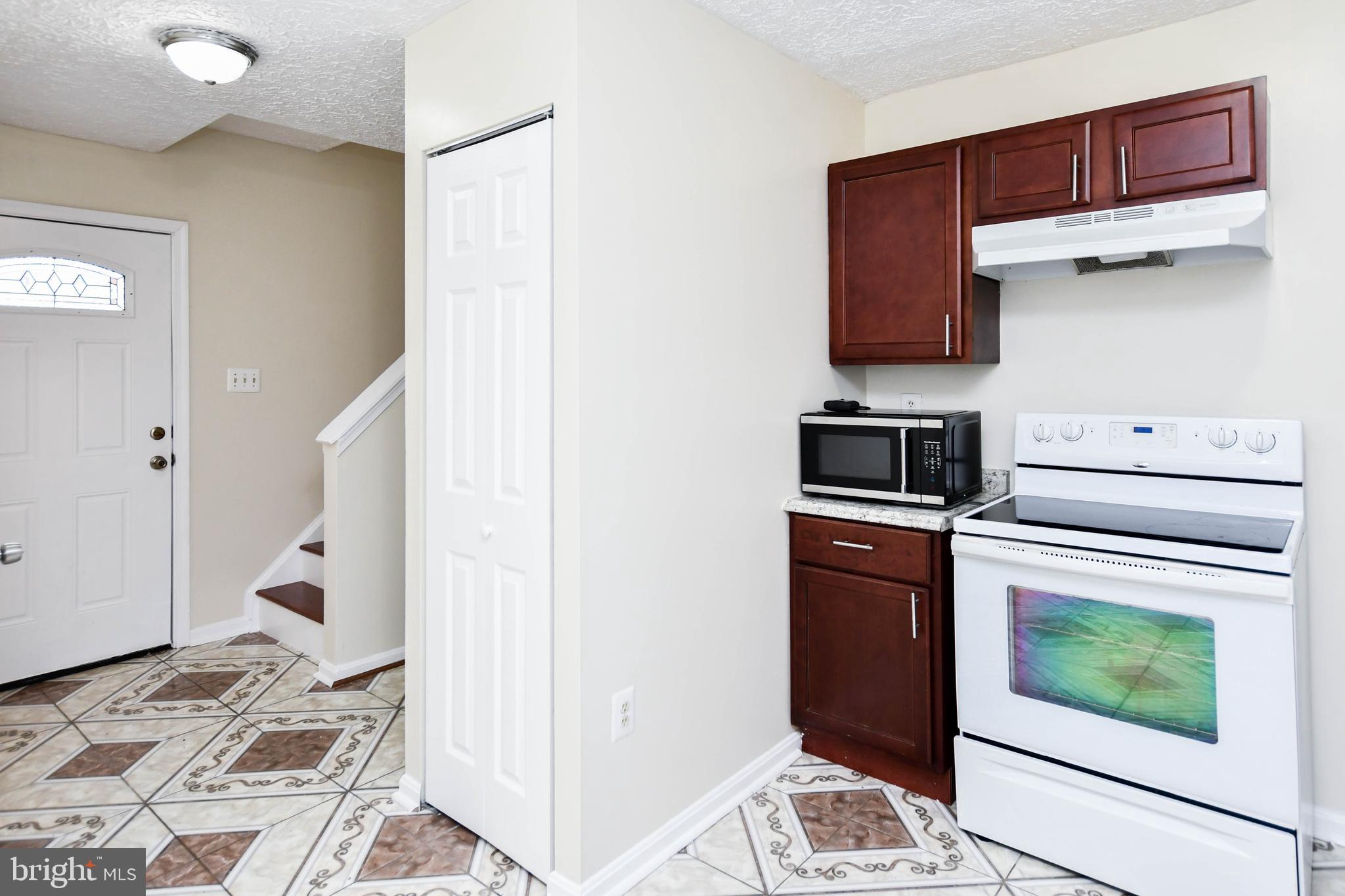 2115 North Anvil Lane Temple Hills, MD 20748 - Photo 6 of 37 a kitchen with a stove top oven and cabinets