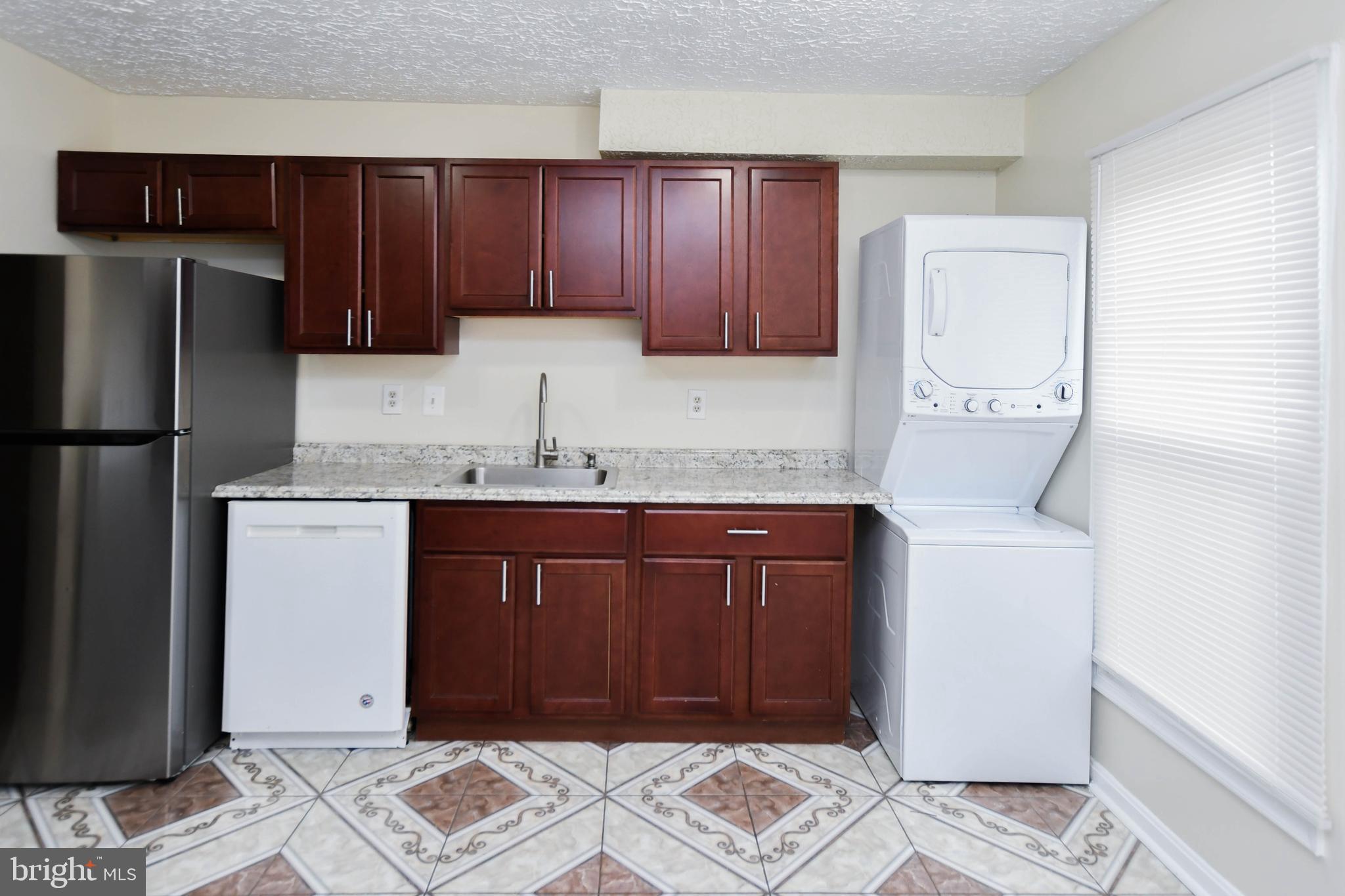 2115 North Anvil Lane Temple Hills, MD 20748 - Photo 8 of 37 a kitchen with stainless steel appliances granite countertop a refrigerator and a stove