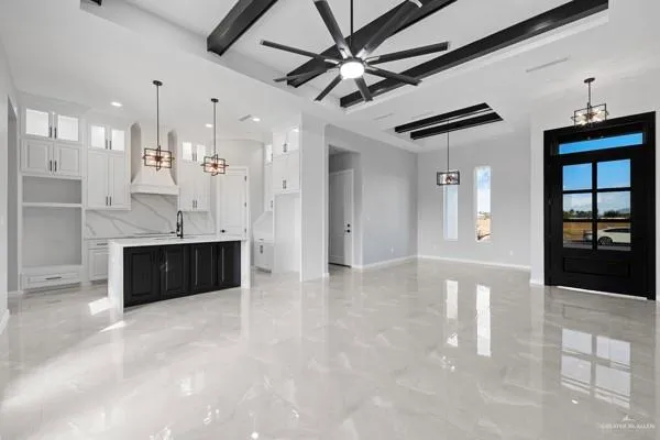 a view of a kitchen with a sink and chandelier