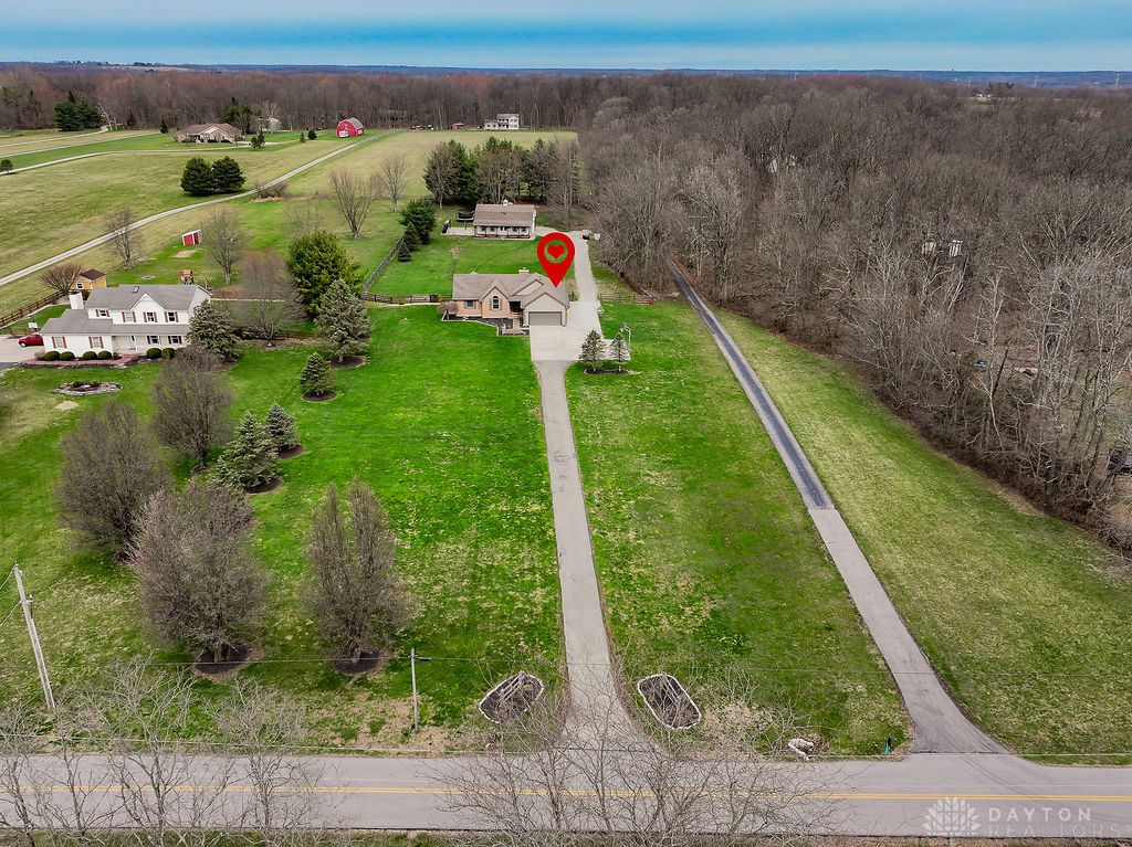 7400 Cook-Jones Road Waynesville, OH 45068 - Photo 5 of 72 An aerial perspective reveals a charming property set amidst expansive, verdant grounds with wooded areas.