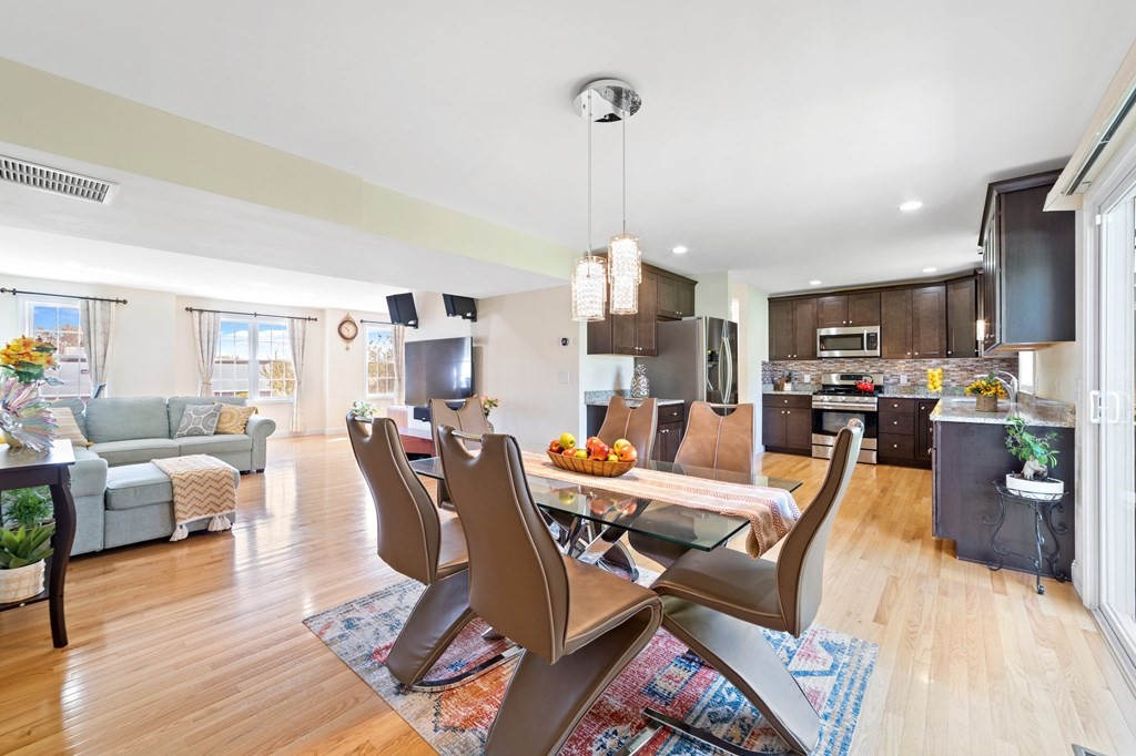 311 Littleton Road, Unit 60 Chelmsford, MA 01824 - Photo 17 of 42 a view of a dining room with furniture a rug and wooden floor