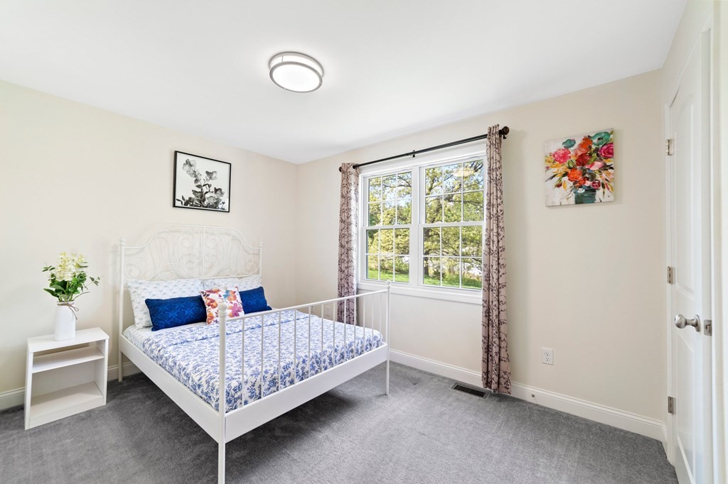 311 Littleton Road, Unit 60 Chelmsford, MA 01824 - Photo 29 of 42 a bedroom with a bed and a window