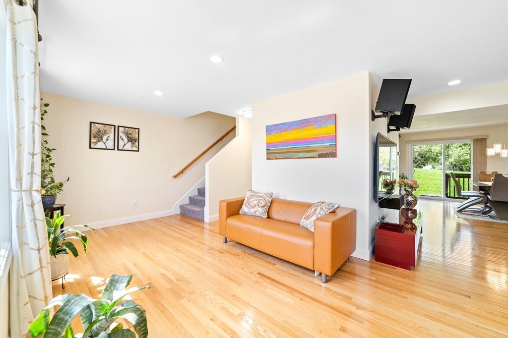 311 Littleton Road, Unit 60 Chelmsford, MA 01824 - Photo 6 of 42 a living room with furniture and a painting on the wall