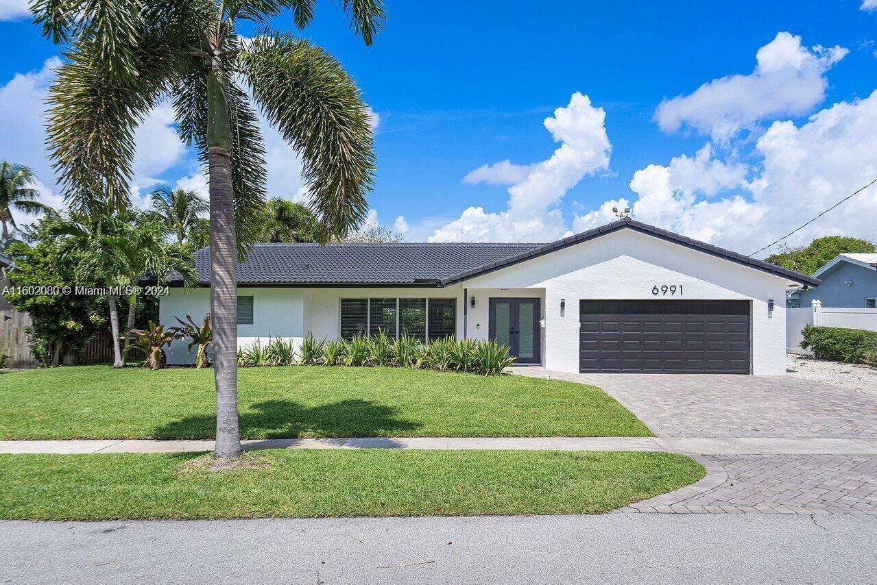 a front view of a house with a yard and garage