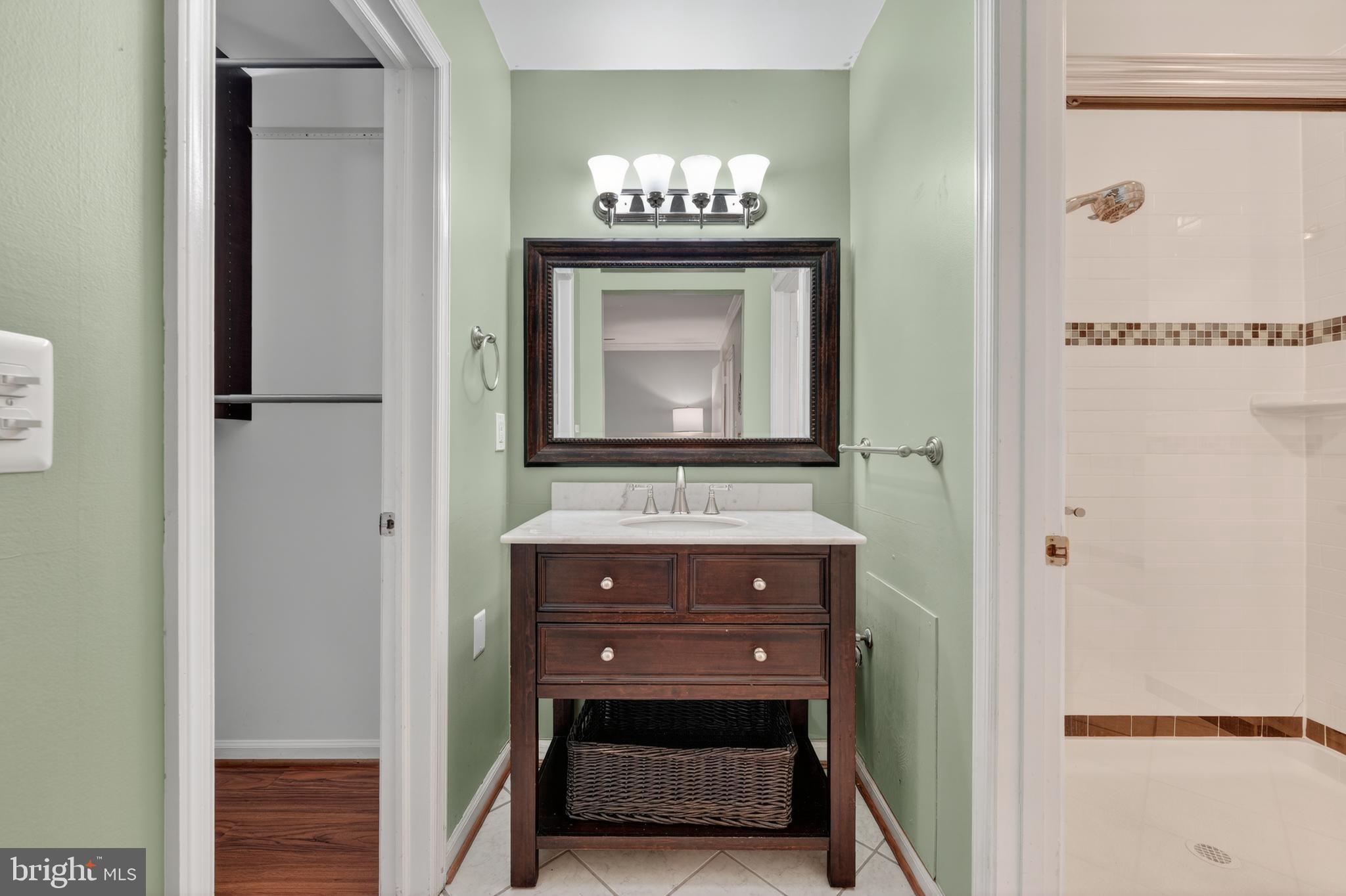 8139 Carrleigh Parkway Springfield, VA 22152 - Photo 20 of 27 a bathroom with a sink and a mirror