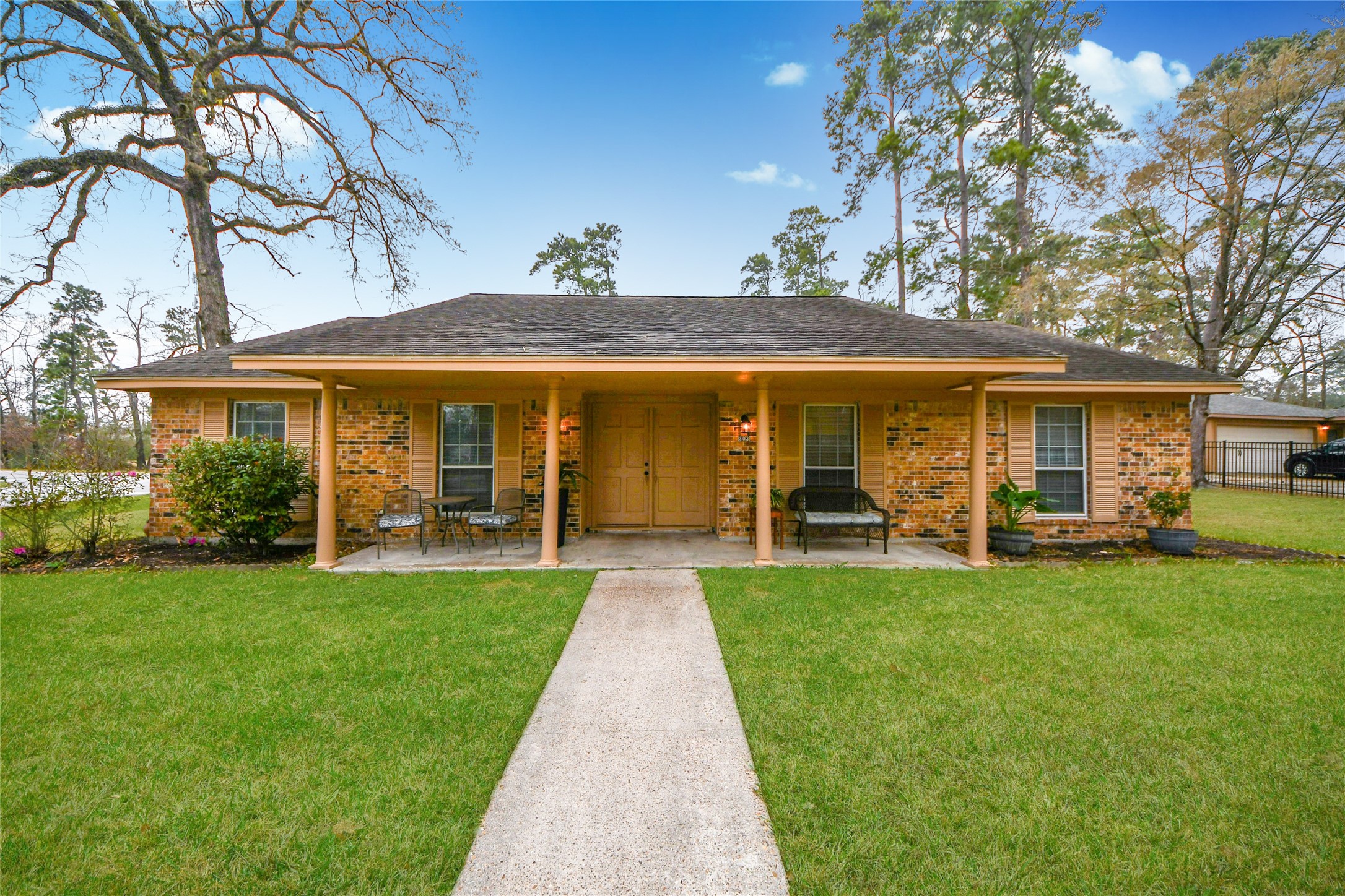 a front view of a house with swimming pool having outdoor seating