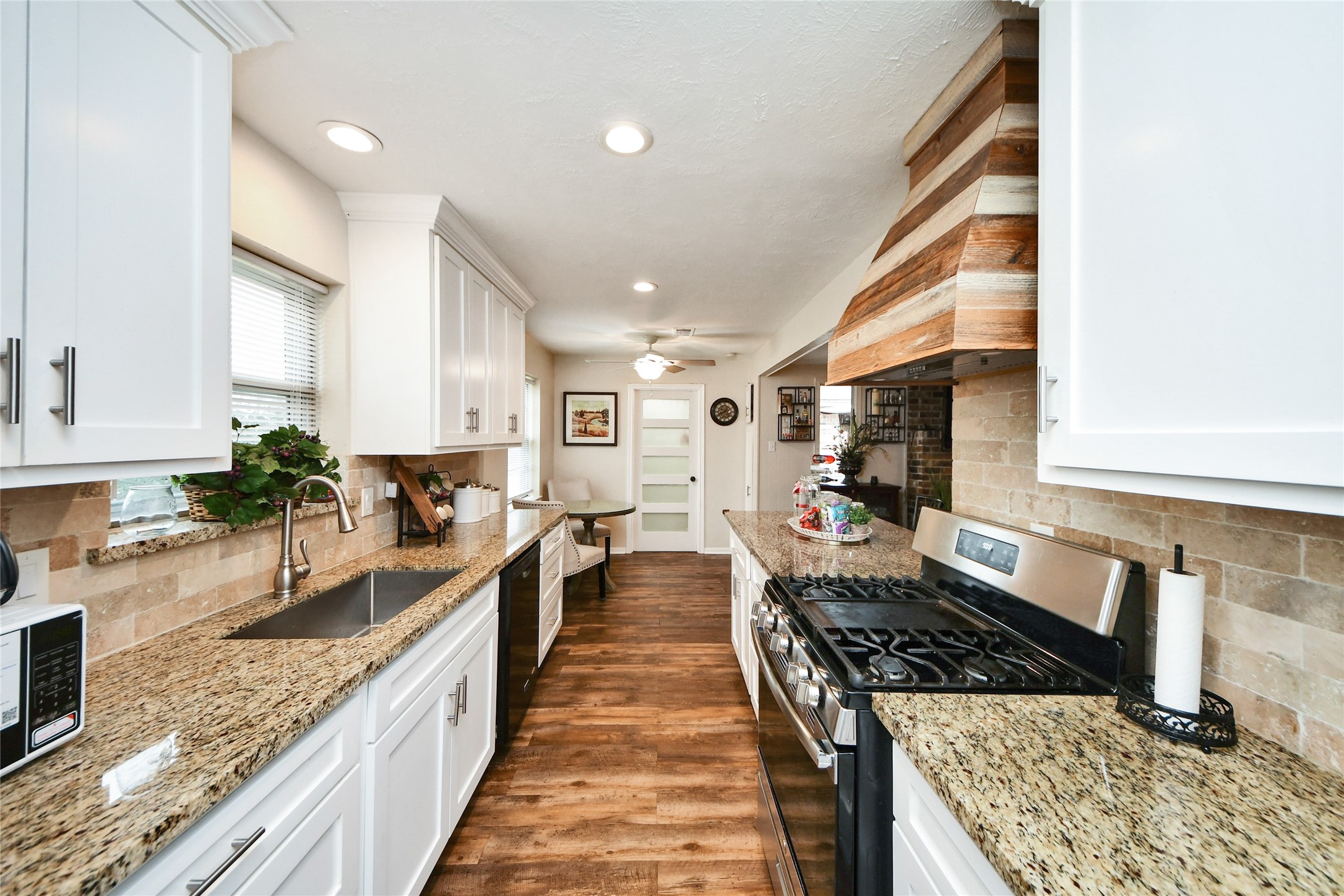 203 Ridgewood Drive Oak Ridge North, TX 77386 - Photo 11 of 39 a large kitchen with stainless steel appliances granite countertop a lot of counter space and a sink