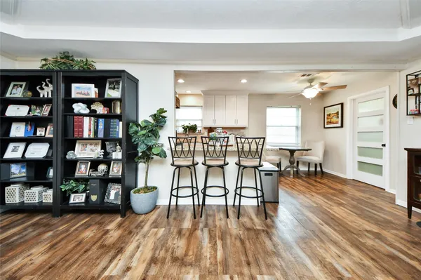 a living room with furniture a chandelier and a flat screen tv