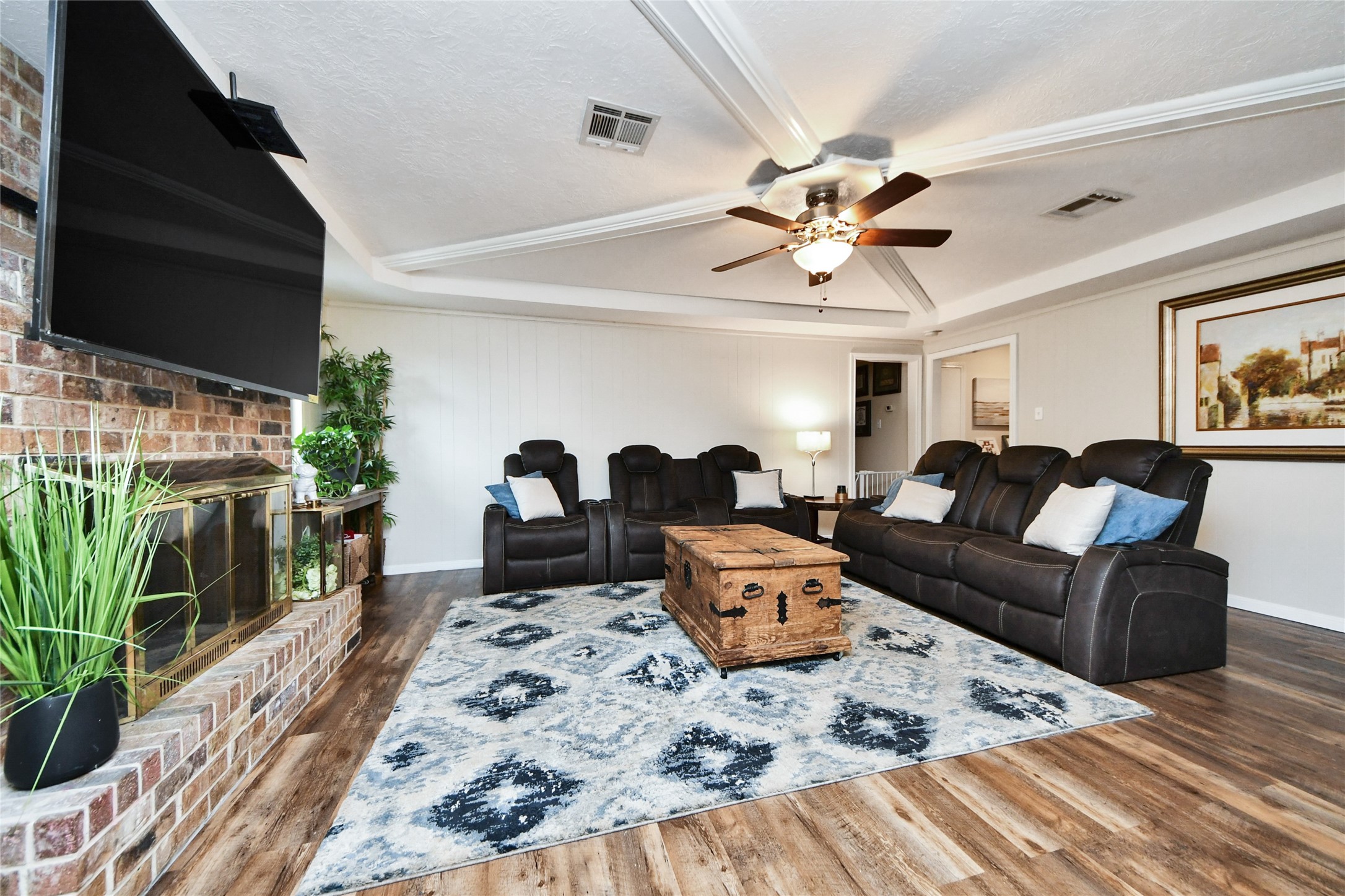 203 Ridgewood Drive Oak Ridge North, TX 77386 - Photo 19 of 39 a living room with furniture a chandelier and a flat screen tv