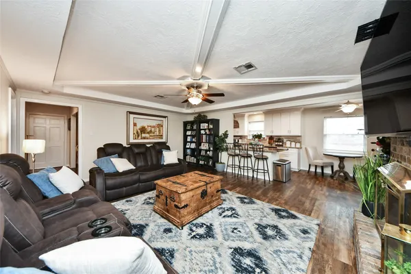 a living room with furniture a flat screen tv and a fireplace