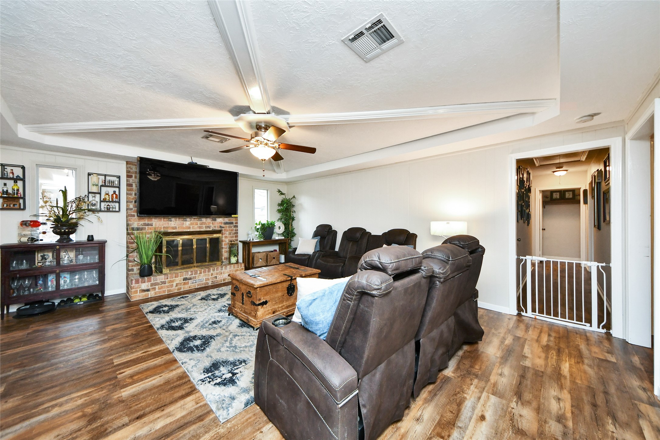 203 Ridgewood Drive Oak Ridge North, TX 77386 - Photo 21 of 39 a living room with furniture a flat screen tv and a fireplace