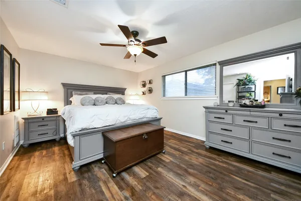 a bedroom with a large bed and a chandelier
