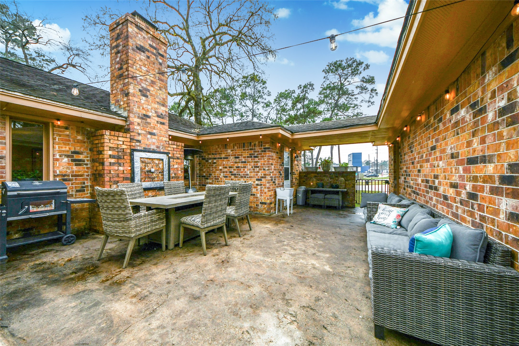 203 Ridgewood Drive Oak Ridge North, TX 77386 - Photo 32 of 39 a view of a patio with table and chairs and potted plants