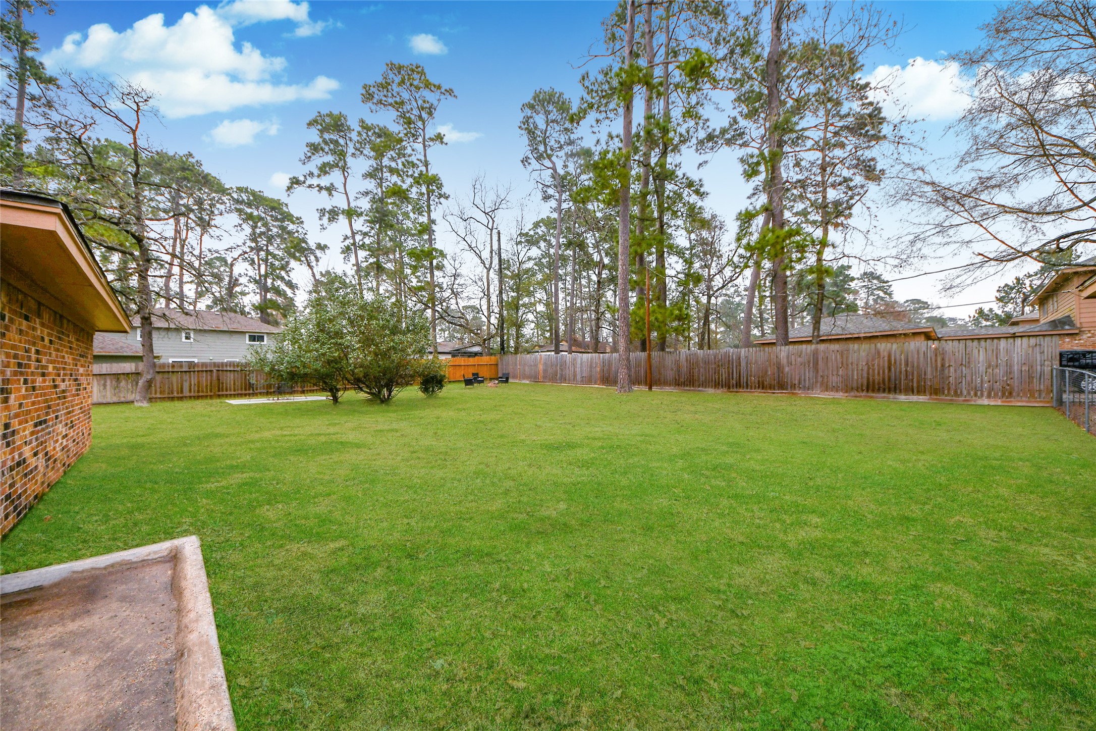 203 Ridgewood Drive Oak Ridge North, TX 77386 - Photo 33 of 39 a view of a backyard with a garden