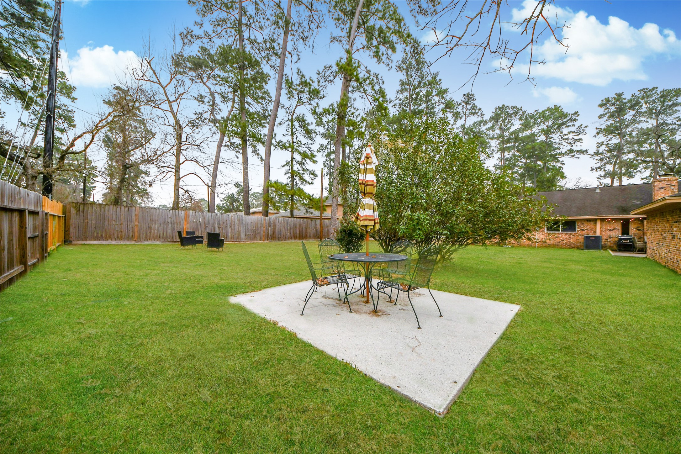 203 Ridgewood Drive Oak Ridge North, TX 77386 - Photo 36 of 39 a view of a chair and table in the garden