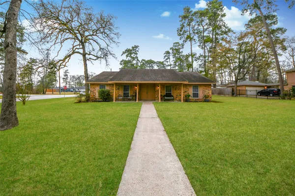 a front view of a house with yard and green space