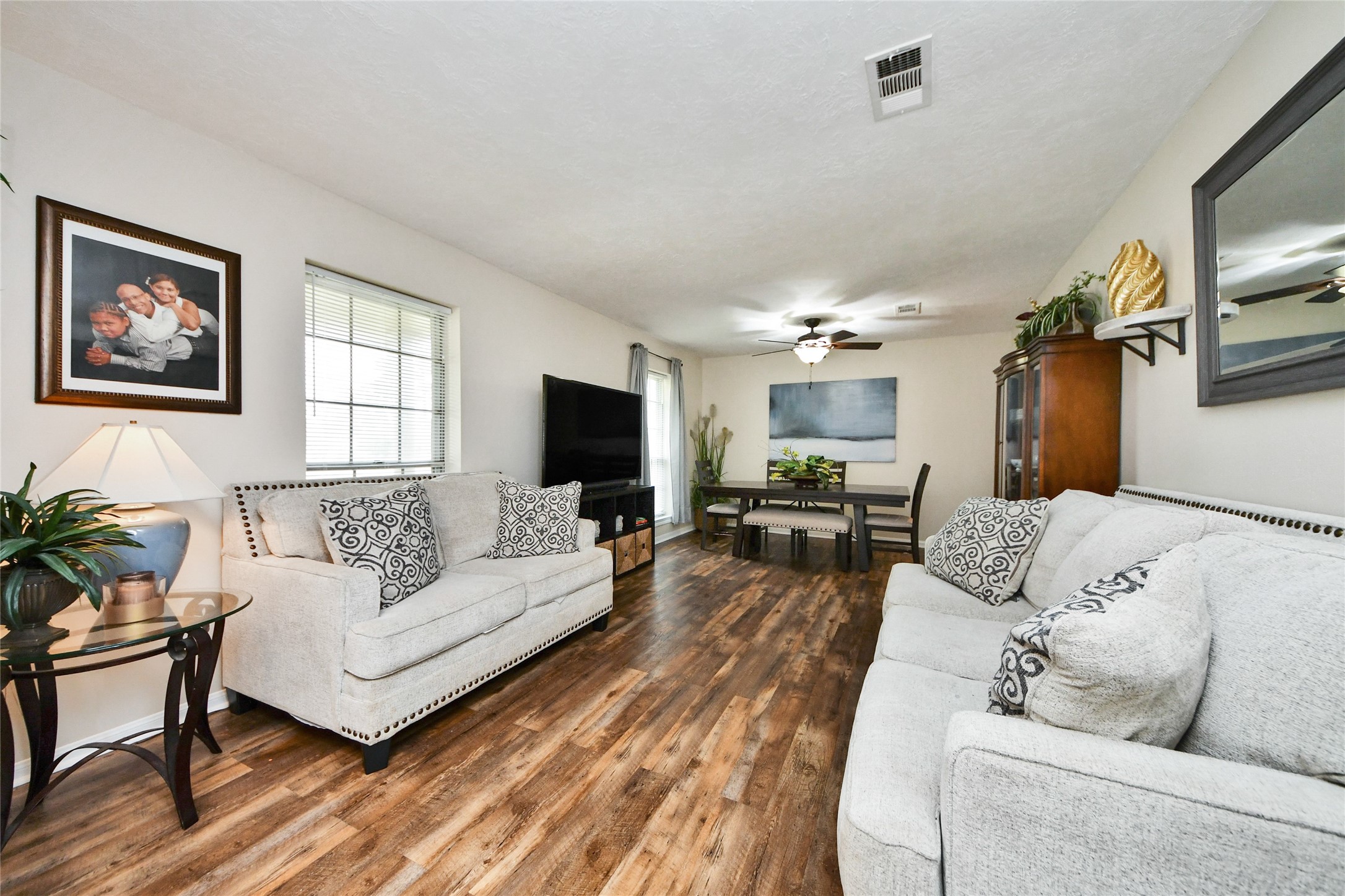 203 Ridgewood Drive Oak Ridge North, TX 77386 - Photo 6 of 39 a living room with furniture and a flat screen tv