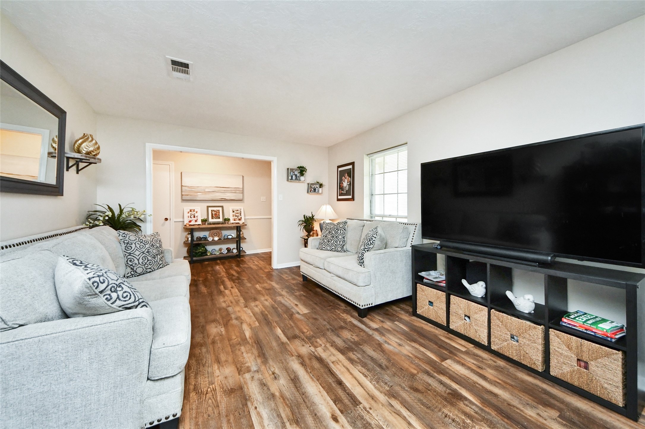 203 Ridgewood Drive Oak Ridge North, TX 77386 - Photo 7 of 39 a living room with furniture and a flat screen tv