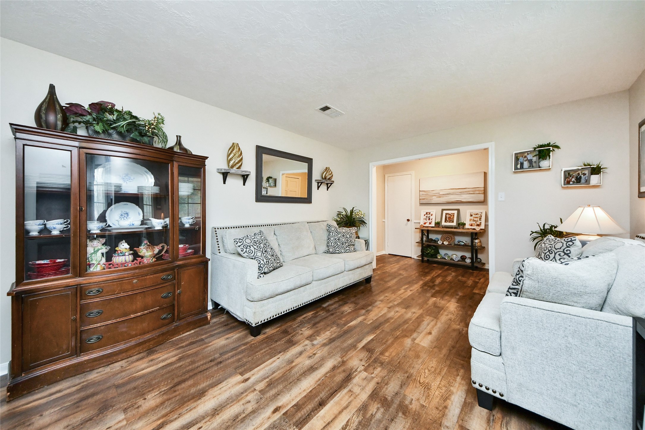 203 Ridgewood Drive Oak Ridge North, TX 77386 - Photo 8 of 39 a living room with furniture and a fireplace