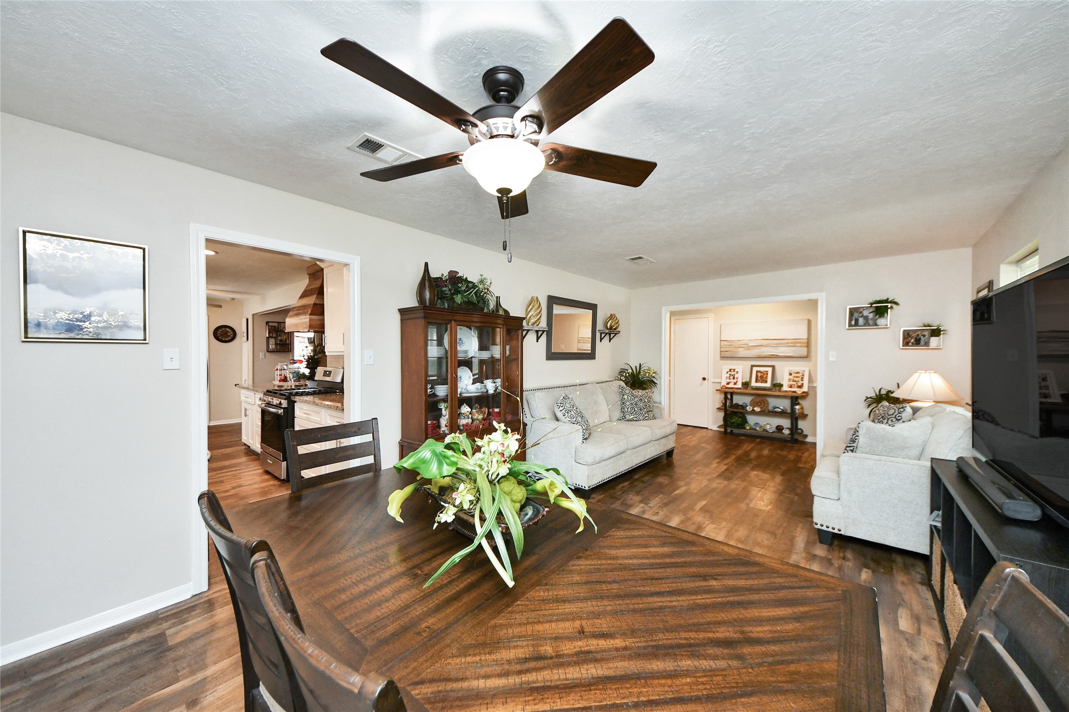 203 Ridgewood Drive Oak Ridge North, TX 77386 - Photo 9 of 39 a living room with furniture and a flat screen tv