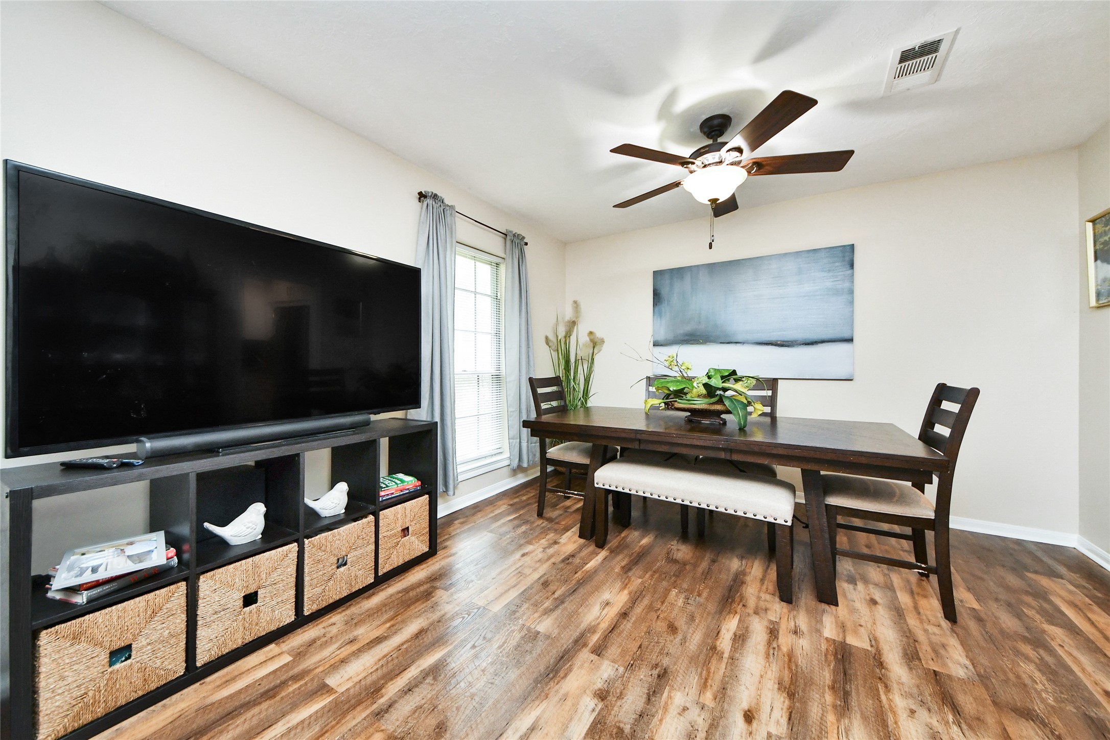 203 Ridgewood Drive Oak Ridge North, TX 77386 - Photo 10 of 39 a living room with furniture and a flat screen tv