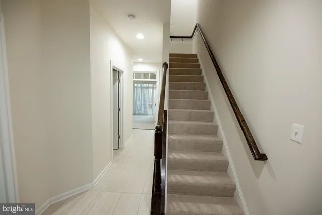 a view of entryway and gallery with wooden floor