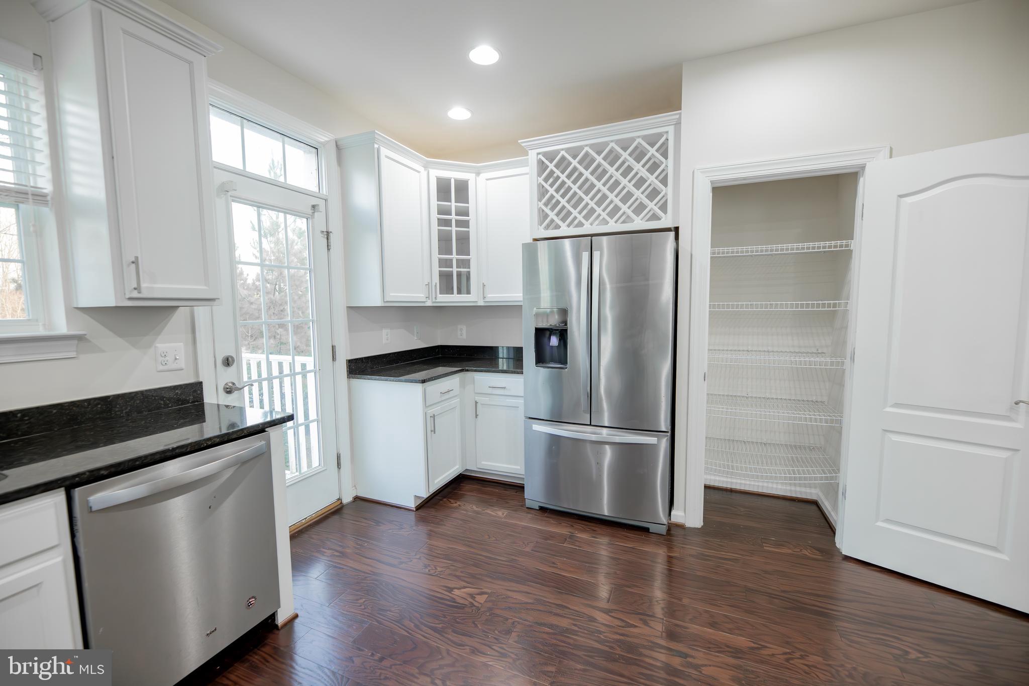 7386 Riding Meadow Way Manassas, VA 20111 - Photo 8 of 8 a kitchen with a refrigerator and a sink