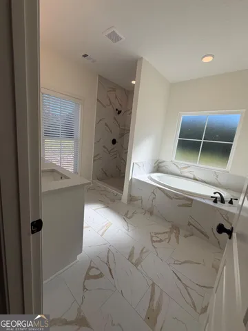 a bathroom with a tub and shower