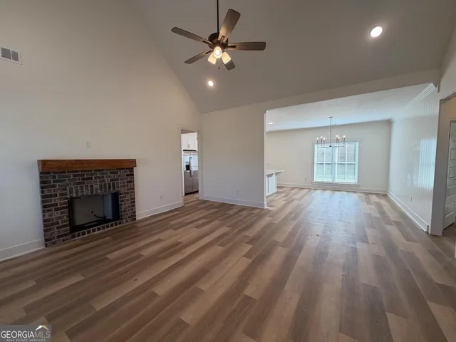 wooden floor fireplace and natural light in room