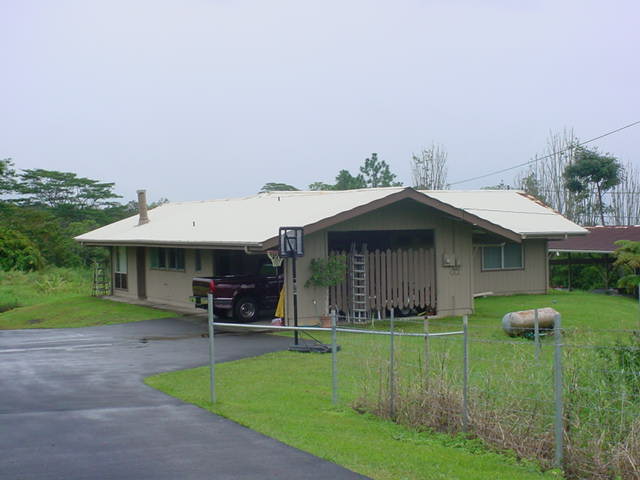 52 Hoaka Road Hilo, HI 96720 - Photo 1 of 11 a backyard of a house with table and chairs