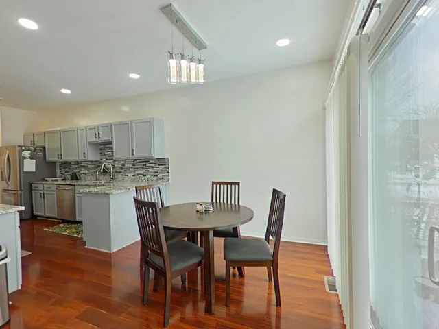 a view of a dining room with furniture and wooden floor