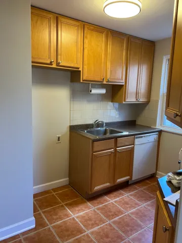 a kitchen with granite countertop cabinets and window