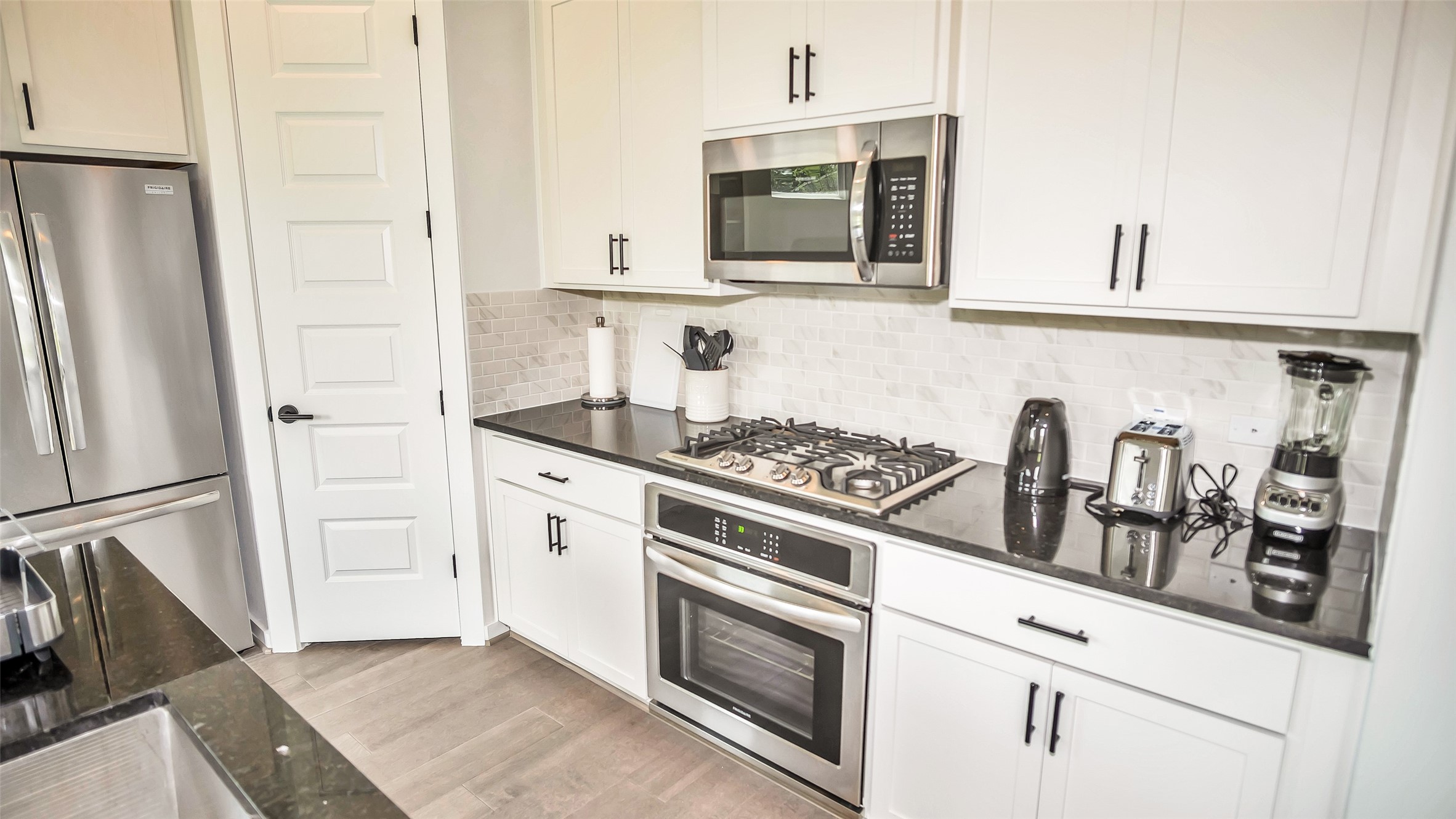 1919 Pueblo Nuevo Path Houston, TX 77077 - Photo 50 of 50 a kitchen with stainless steel appliances white cabinets and a stove