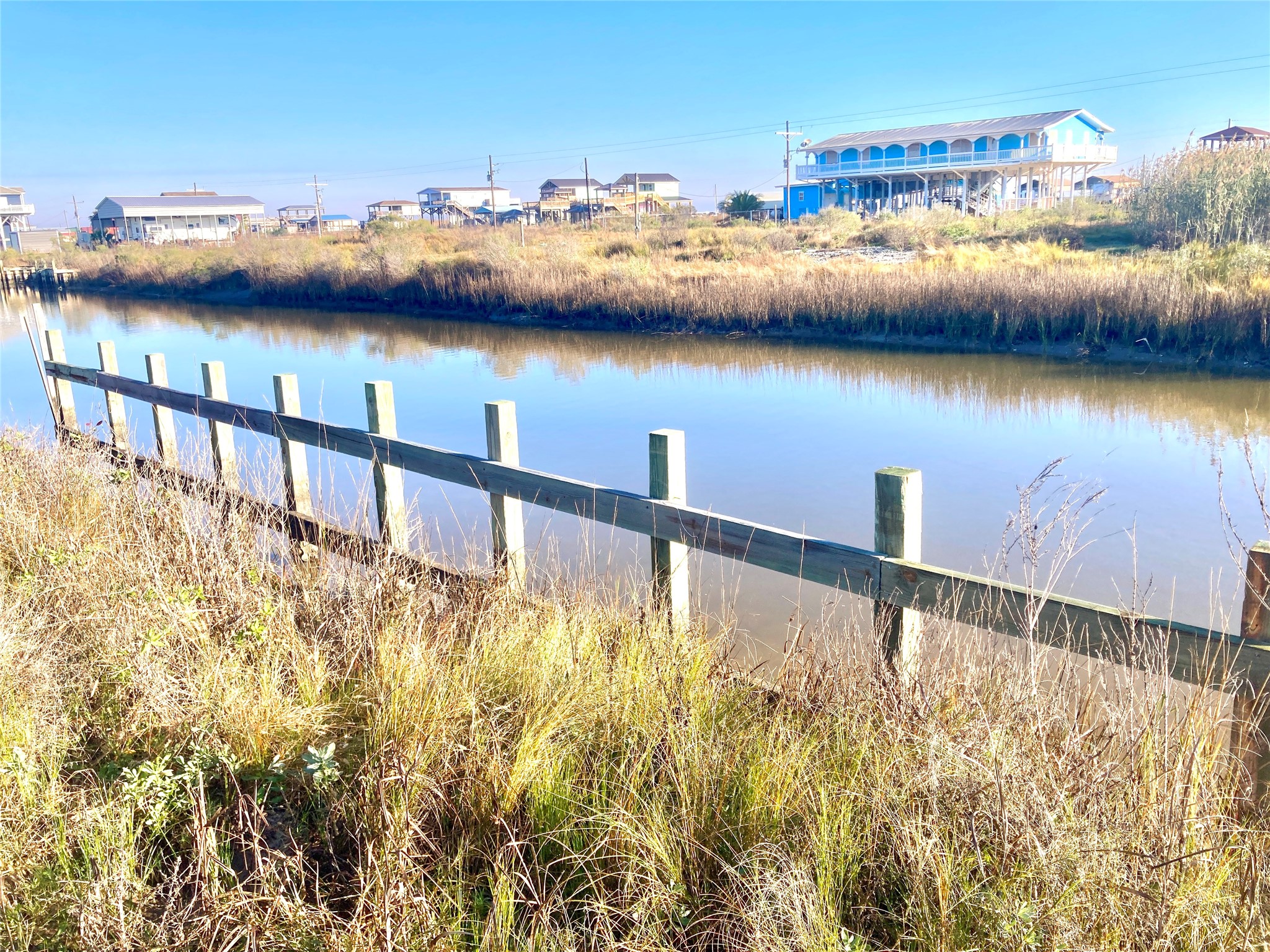 1136 Pennington Port Bolivar, TX 77650 - Photo 1 of 7 a view of a city and trees in front of house