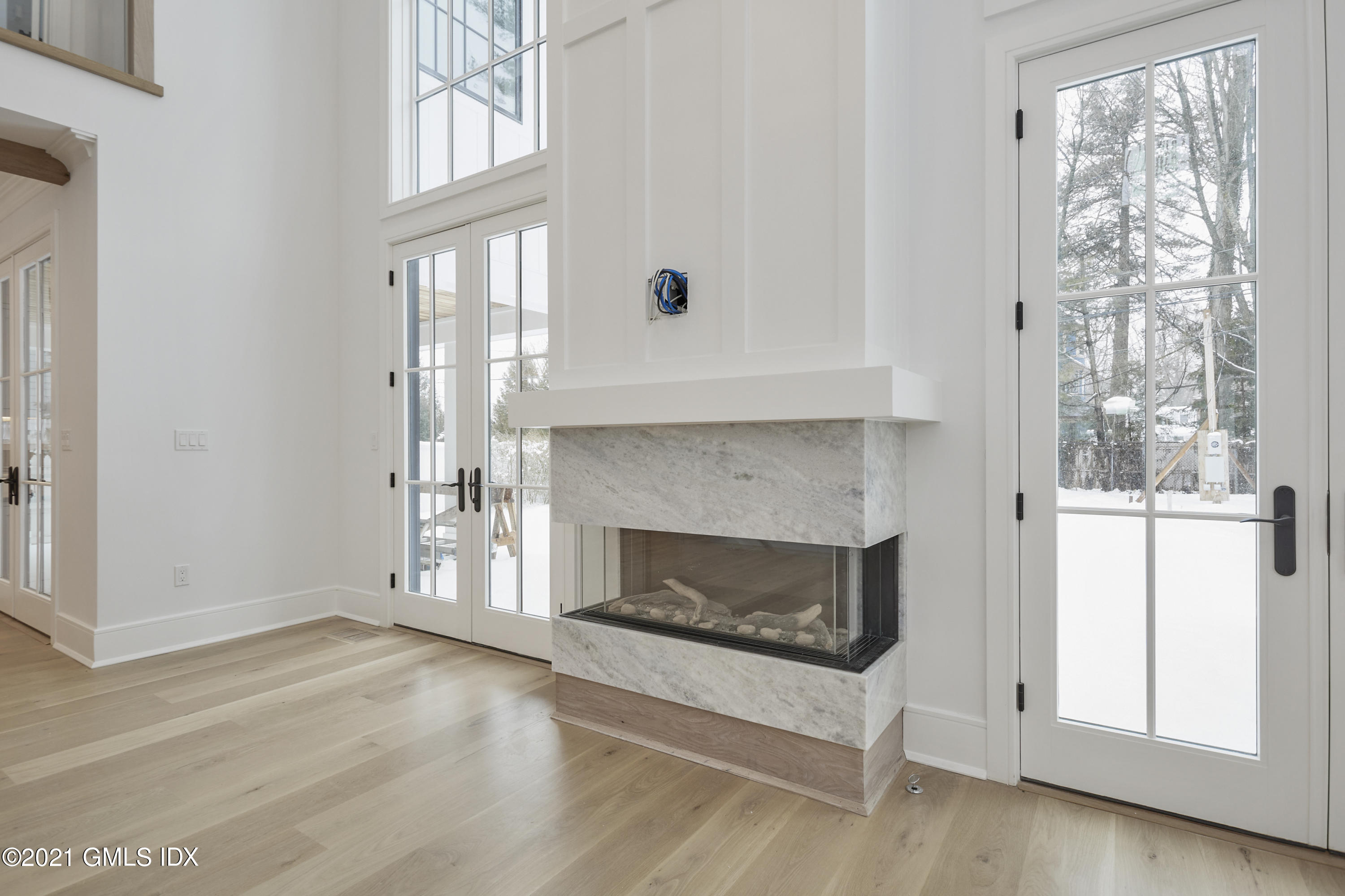 5 Chapel Lane Riverside, CT 06878 - Photo 19 of 46 a living room with a fireplace with wooden floor
