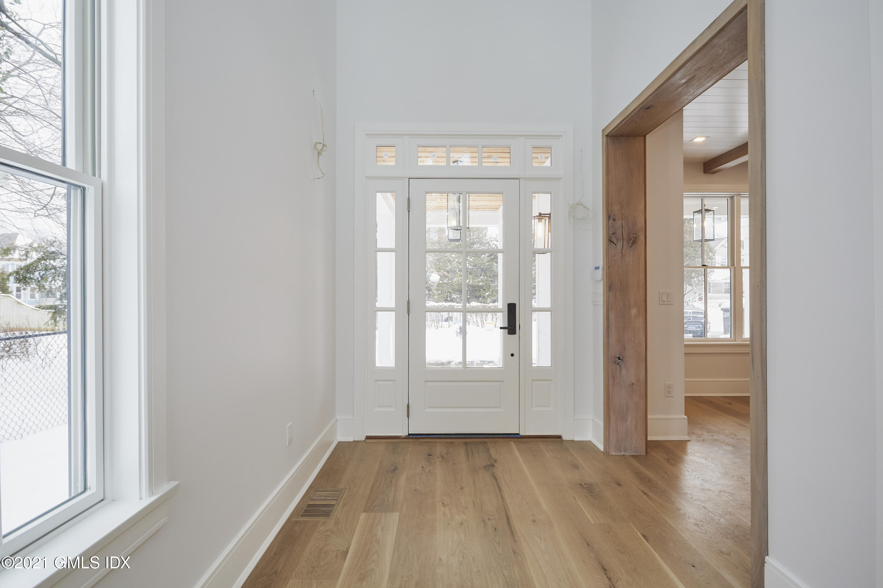 5 Chapel Lane Riverside, CT 06878 - Photo 3 of 46 an empty room with wooden floor and windows