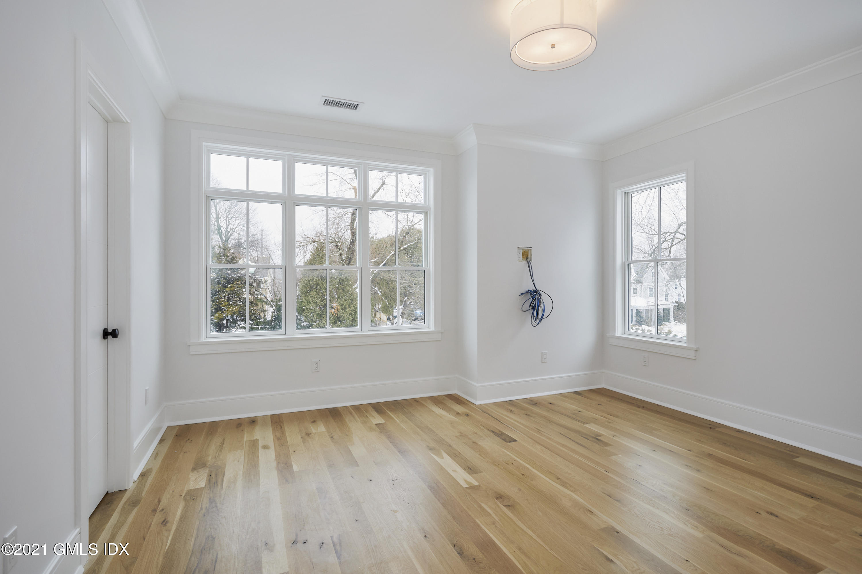 5 Chapel Lane Riverside, CT 06878 - Photo 36 of 46 a view of an empty room with wooden floor and a window