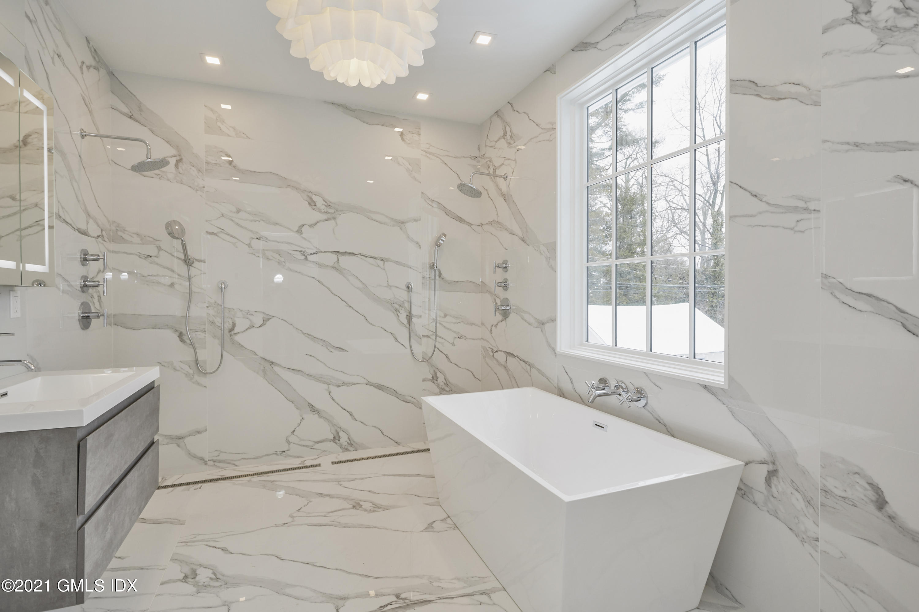5 Chapel Lane Riverside, CT 06878 - Photo 38 of 46 a bathroom with a bathtub a sink a vanity and a shower