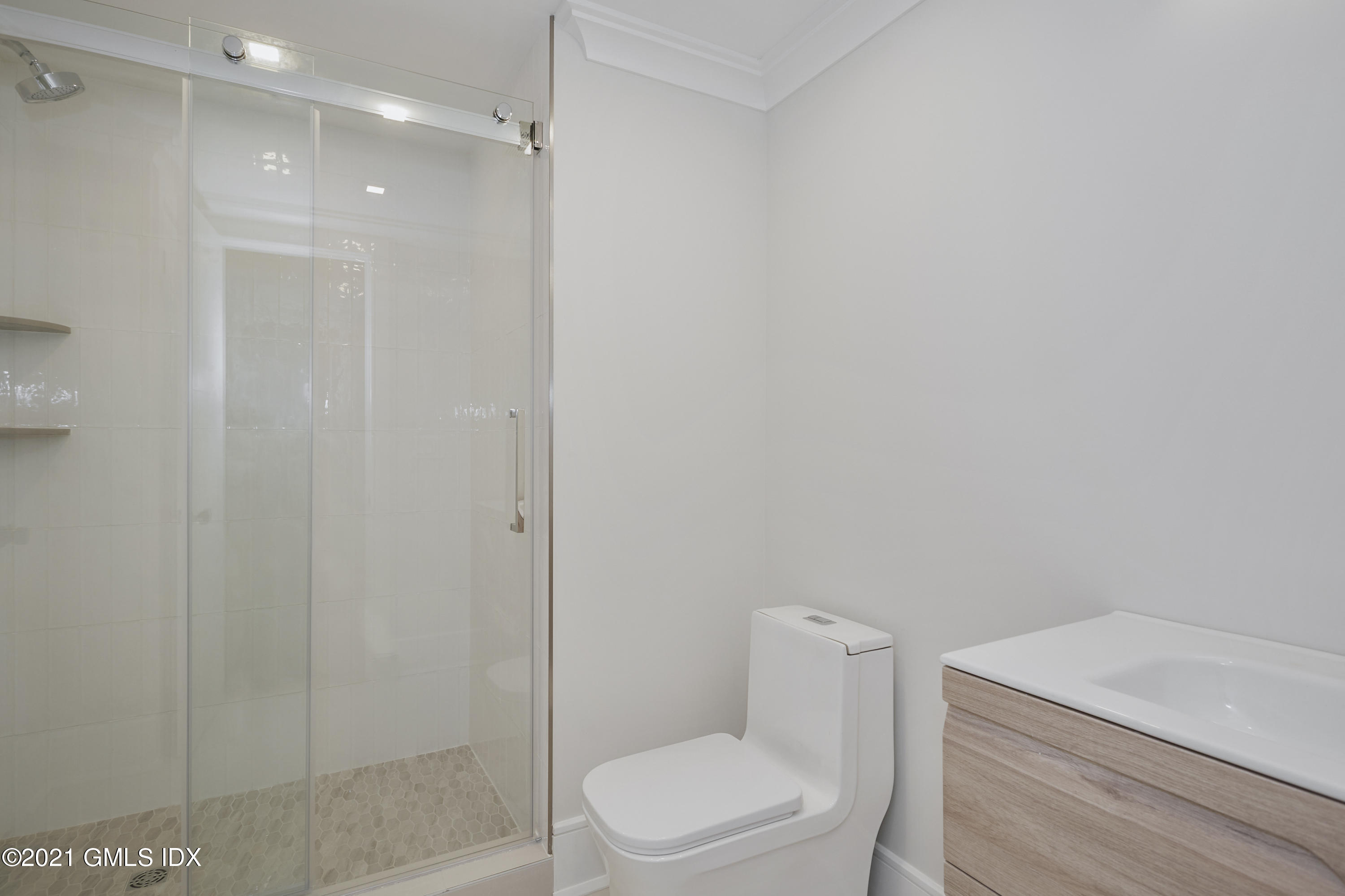 5 Chapel Lane Riverside, CT 06878 - Photo 46 of 46 a white toilet sitting next to a shower