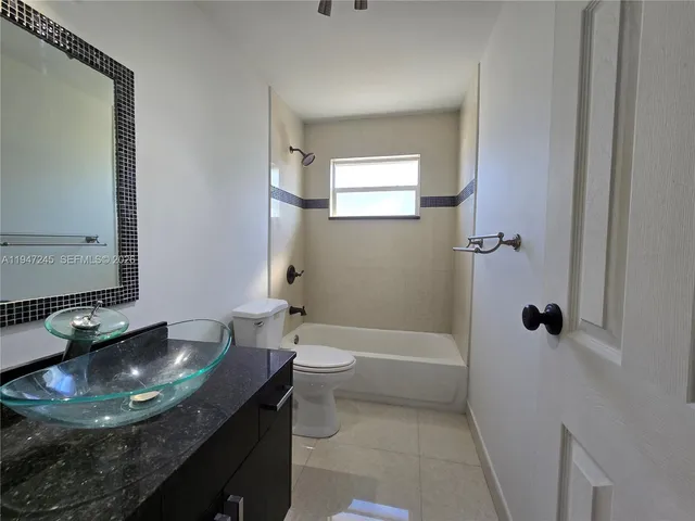 a view of a room with wooden floor and windows