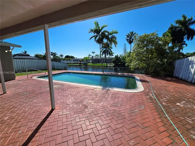 a view of swimming pool with seating space