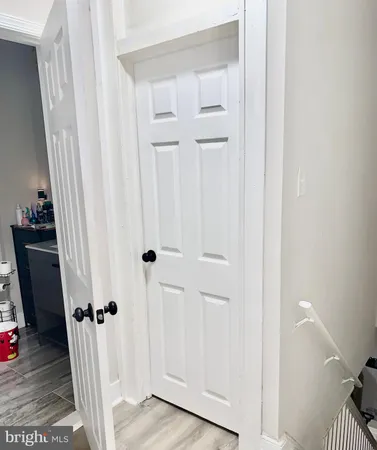a view of a livingroom with wooden floor and staircase