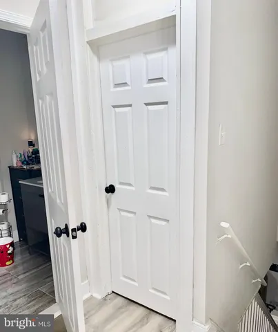 a view of a livingroom with wooden floor and staircase