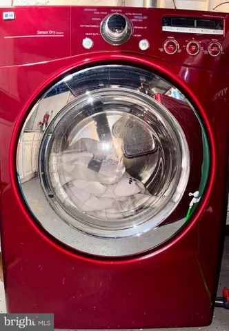 a view of washer and dryer with a kitchen view