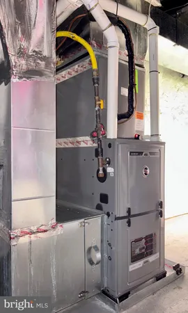 a utility room with fridge and window